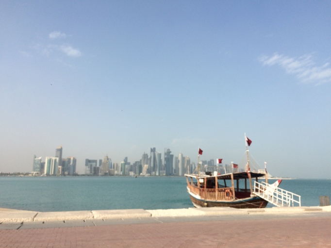 The old and the new, a traditional dhow boat and downtown Doha